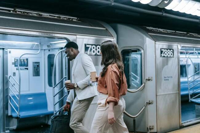 Two people entering a subway train